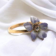 We love great conversion pieces such as this! Originally a stick pin & repurposed into a dainty fashion ring. This beauty features magnificent enamel work along with a tiny diamond in the center of the flower. Metal: 10K Yellow Gold Shank Width: 1.65mm Finger Size: 7 Weight: 2.0 Grams Some Minor Enamel Loss On Flower Item: 768TMUP Enamel Flower Ring For Anniversary, Heirloom Enamel Jewelry For Weddings, Unique Enamel Wedding Ring, Vintage Wedding Enamel Ring, Vintage Enamel Ring With Rose Cut Diamonds As Gift, Gold Enamel Flower Ring For Anniversary, Flower Shaped Enamel Jewelry For Wedding, Elegant Floral Enamel Ring For Wedding, Anniversary Flower Enamel Ring