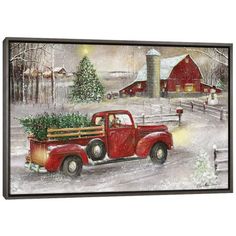 an old red truck with a christmas tree in the bed is parked near a barn