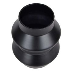 a black vase sitting on top of a white table