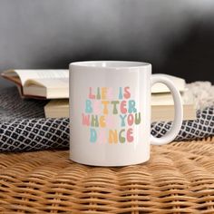 a white coffee mug with the words life is better when you dance printed on it