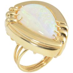 Large statement cocktail ring featuring a pear shaped opal mounted in a 1970s 14k yellow gold stylized frame. US Size: 6. It can be resized. Ladies Bangles, Boulder Opal Ring, Diamond Bracelet Design, Amethyst And Diamond Ring, Opal Ring Gold, Gold Statement Ring, Gold Cocktail Ring, Gold Cocktail, Domed Ring