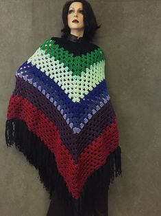 "Crochet Poncho/ XL Colors: Black, green red Size: Plus Size/ One size fits most Measurements. Poncho = approximately 47\" from neckline to end of fringe (fringe = 7.5\") Care:  Machine wash on gentle cycle/ warm water/ Dry on cool cycle  OR hand wash/ Lay flat to dry  I crochet this  poncho from the \"Coming Home \"pattern. It's made in shades of green graduating to purples ,then reds ending in a  luxurious 8\" black fringe. **NOTE: A small to average sized person CAN wear this poncho, however Poncho Au Crochet, Crochet Poncho Free Pattern, Ladies Poncho, Crochet Coat, Crochet Fall, Yarn Sizes, Crochet Poncho, Black Fringe, Crochet Accessories