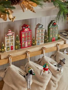 christmas stockings hanging on a shelf with decorations