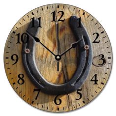 a clock with a horseshoe hanging from it's side