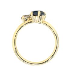 a yellow gold ring with two stones on it