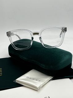 The Gucci GG0184O 012 Clear Square Frames fuse style and unisex appeal. The trendy clear frames are square-shaped and finished with sleek silver hardware. These glasses offer the perfect blend of fashion and functionality. Measures 50-21-145. Arrives in Gucci jewel toned velvet case, cleaning cloth, satin pouch and authenticity cards. 100% authentic. Made in Italy. Modern Clear Sunglasses For Formal Occasions, Modern Clear Sunglasses For Formal Events, Formal Clear Glass Sunglasses, Gucci Clear Glass Sunglasses, Gucci Clear Square Frame Sunglasses, Gucci Designer Clear Sunglasses, Designer Gucci Clear Sunglasses, Trendy Clear Sunglasses For Formal Occasions, Luxury Clear Gucci Sunglasses