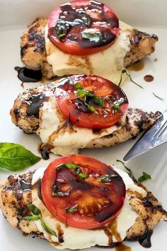 grilled chicken with tomatoes, mozzarella and basil on a white platter