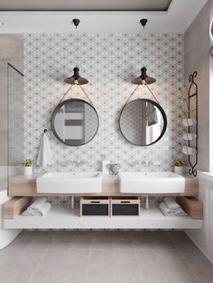 a bathroom with two sinks and mirrors on the wall