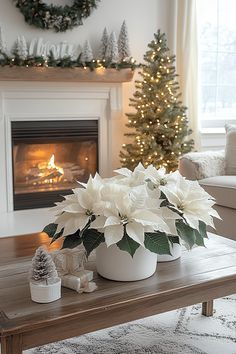 a living room decorated for christmas with white poinsettis in the centerpiece