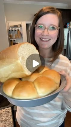 a woman holding a plate with bread on it