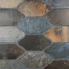 a close up view of an old tile floor that has been cleaned and stained with different colors