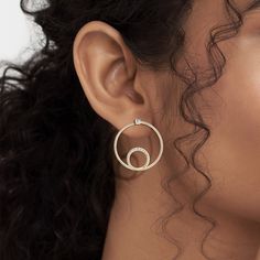 The Shimmering Loop Bardot Hoops are artistic and minimalistic. They're made with solid gold and ethically sourced natural diamonds, adding a touch of shimmer to any outfit. The loop design adds an element of movement to the hoops, making them a dynamic addition to your jewelry collection. Modern Round Cut Halo Diamond Earrings, Gold Diamond Circle Jewelry, Gold Circular Diamond Jewelry, Modern Hoop Jewelry With Pave Setting, Timeless Gold Diamond Earrings With Pave Setting, Timeless Gold Diamond Earrings With Single Cut, Modern Rose Gold Jewelry With Single Cut Diamonds, Modern Round Diamond Earrings, Modern Open Circle Wedding Jewelry