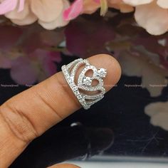 a woman's hand with a diamond ring on it