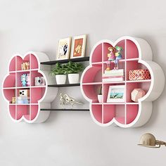 the wall shelfs are decorated with pink and white shelves that have hearts on them