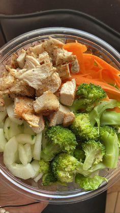 a bowl filled with meat and vegetables on top of a table