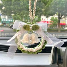 a car dashboard with a wreath and bells hanging from it