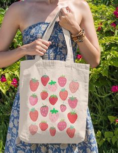 Check out this aesthetic strawberry bag on this quality canvas tote bag! This fruity design is simple yet sweet. Use this graphic design tote as a grocery bag, book bag, or whatever!! **Please double-check your address so you can get this cute tote bag. I am not responsible for incorrect addresses** * Care Instructions * Empty the bag before washing. We suggest using stain remover on any visible stains. Please use laundry detergent and warm water with a soft-bristle brush to clean. Please let th Summer Strawberry Print Bags For Daily Use, Summer Strawberry Print Bag For Daily Use, Strawberry Print Tote Bag For Daily Use, Everyday Tote Bag With Strawberry Print, Daily Use Strawberry Print Tote Bag, Cute Strawberry Print Tote Bag, Simple Tote Bag Design, Paint Tote Bag Ideas, Aesthetic Tote Bag Design