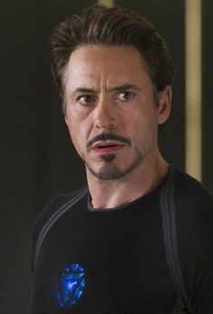 the avengers movie character is looking at something with an intense look on his face and chest