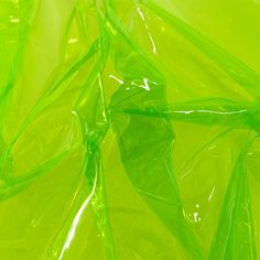 green plastic bags are stacked on top of each other