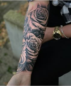 a woman with a black and white rose tattoo on her arm