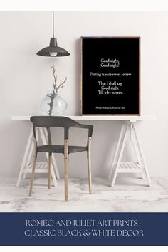 a black and white poster on the wall above a table with two chairs in front of it