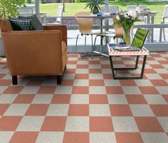 a living room filled with furniture and a checkered flooring pattern on the floor