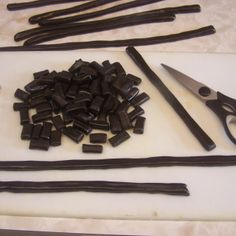 there are many different types of chocolates on the table with scissors and tongs