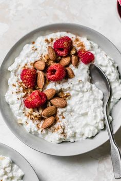 a bowl of yogurt with raspberries and almonds