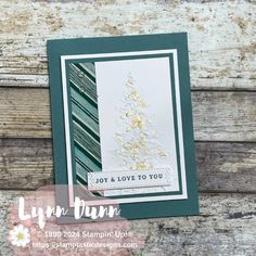 a close up of a card with a christmas tree on it and the words joy & love to you