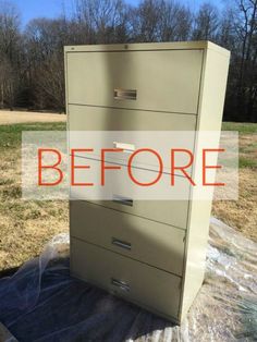 a file cabinet sitting on top of a tarp covered field