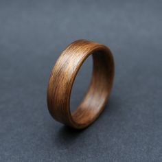 a wooden ring is shown on a gray surface