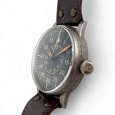 The A. Lange & Söhne B-uhr FL23883 is a remarkable piece of horological history, specifically designed for the Luftwaffe during World War II. Known as a "Beobachtungsuhr" or "B-Uhr," this pilot's watch was a crucial tool for navigation and mission timing for German pilots and navigators. SPECIFICATIONS Brand: A. Lange & SöhneModel: B-uhr World War II Pilot's watchReference Number: FL23883Movement: Manual windingCondition: GoodGender: Men’sTime Period: 1940sBox: NoPapers: No THE CALIBER Caliber: Antique Automatic Watches With Round Dial, Luxury Watch Collection, Luftwaffe Pilot, Aviator Watch, Pilot Watch, Watch Collection, Pilots, Luxury Watch, Quartz Watch