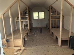 the inside of a building being built with wooden beams and plywood flooring in place