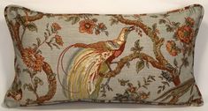 a decorative pillow with a bird on it