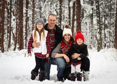 a family poses for a photo in the snow