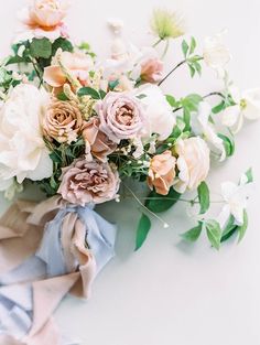 a bouquet of flowers on a white surface