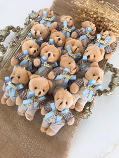 a bunch of brown teddy bears sitting on top of a table