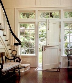 the inside of a house with wooden floors and white walls, windows, and doors