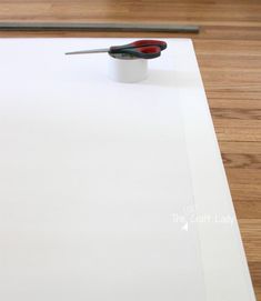 a pair of scissors sitting on top of a piece of white paper next to a pencil