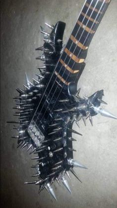 an electric guitar with lots of spikes on it