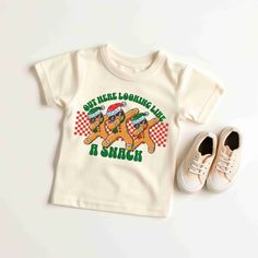 "Toddlers will look adorable in this \"OUT HERE LOOKING LIKE A SNACK CHRISTMAS\" SANTA youth short sleeve tee. This lightweight side-seamed shirt maximizes comfort all day long.  Gingerbread Out Here Looking Like A Snack Toddler Baby TShirt, Cute Santa Claus Shirt, Retro Christmas T-Shirt, Funny Santa Tee, Holiday Sweater, Santa Gift, Santa Funny tshirt, Cute Santa shirt, Retro Santa Shirt, Christmas Sweatshirt, Christmas Santa Shirts, Cute Retro Gingerbread Santa Shirt, Classic Christmas Shirt, Snack Christmas, Gingerbread Santa, Gingerbread Shirt, Santa Graphic, Santa Tee, Christmas Pullover, Santa Sweatshirt, Retro Santa, Santa Shirt