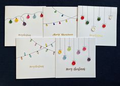 three christmas cards with ornaments hanging from them