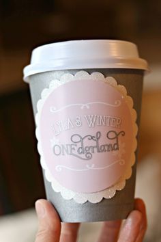 a person holding up a coffee cup with the words, lilas winter one england on it