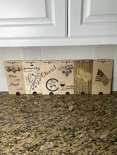 four wine boxes sitting on top of a counter in front of a white cabinet door