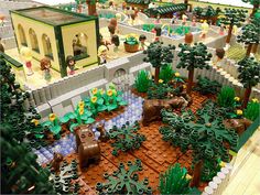 a lego model of a garden with animals and trees