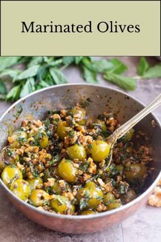 a pan filled with cooked olives and herbs