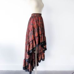 This bohemian hi low ruffle skirt is full of sway and flow. It's a graceful, romantic maxi skirt that's hits at the knee in the center front and drapes beautifully all the way around. A full twirling skirt, this can easily be paired with flats for a day at the beach, or paired with our infinity convertible tops for a more formal occasion. It's lightweight, easy to wash/dry and so easy to pack for all your vacations! Note: You will be stopped and admired when you wear this out! ► Size XS & S of P Cheap Flared Skirt For Beach, Cheap Flared Skirt Bottoms For Beach, Cheap Flowy Skirt For The Beach, Luxury Bohemian Multicolor Maxi Skirt, Cheap Multicolor Flowy Skirt, Maxi Skirt Formal, Bohemian Robes, Pink Bohemian, Long Floral Skirt