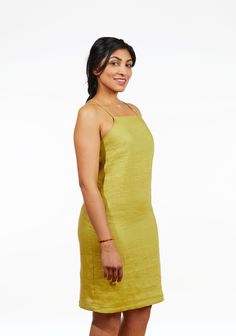 a woman in a yellow dress posing for the camera with her hand on her hip