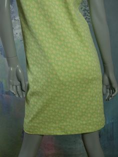 This 1960s Swedish vintage shift dress has a delicate yellow floral pattern on a mint green background. The sleeveless slip-on dress has a square bateau neckline and a green polyester lining. Bust = 37 inches (93.98cm) Waist = 37 inches (93.98cm) Hips = 37 inches (93.98cm) Dress Length = 35.5 inches (90.17cm) Brand label: Ajco (Made in Sweden) Size: 6/8 US/UK Material: Diolen Polyester Condition: Excellent (clean, soft, and supple, with no stains, tears, wear spots, or weaknesses in the seams) - Vintage Green Square Neck Dress, Vintage Light Green Dress For Spring, Green Spring Dress With Straight Neckline, Retro Green Square Neck Dress, Green Square Neck Daywear Dress, Green Mod Cotton Dress, Green Square Neck Dress For Daywear, Mod Green A-line Dress, Green Mod A-line Dress