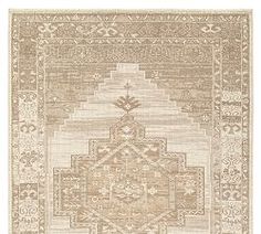 a beige rug with an intricate design on it